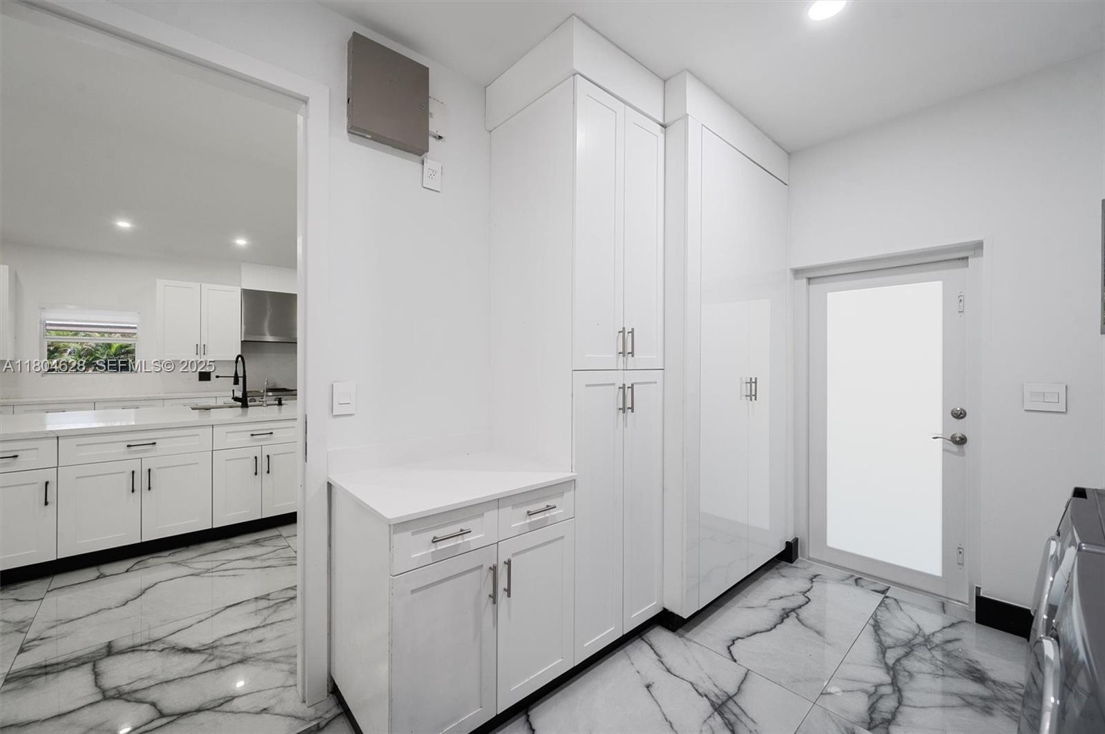 5121 Southwest 210th Terrace Southwest Ranches, FL 33332 - Photo 27 of 70 a kitchen with white cabinets and white appliances