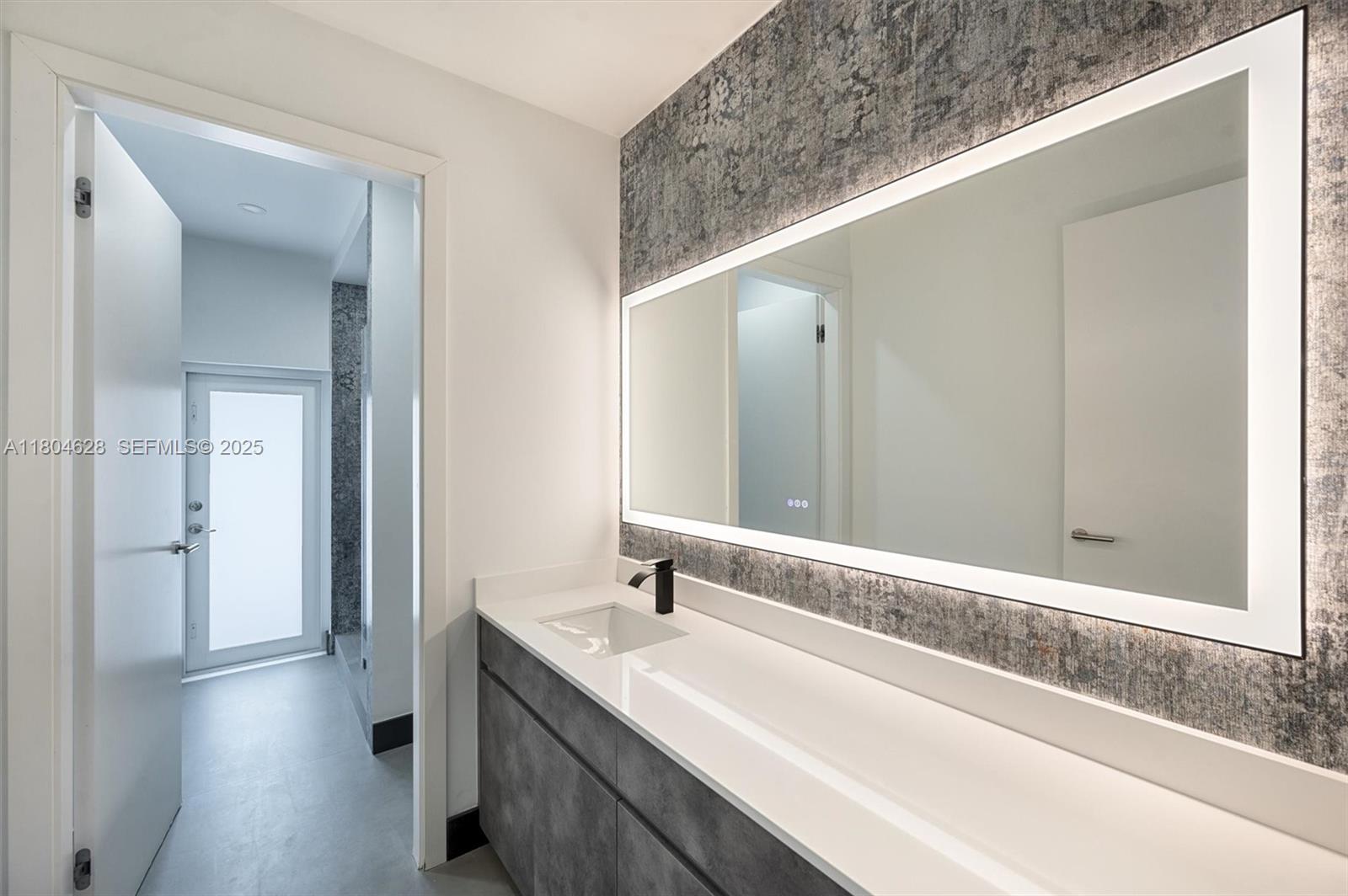 5121 Southwest 210th Terrace Southwest Ranches, FL 33332 - Photo 29 of 70 a bathroom with a double vanity sink and a mirror