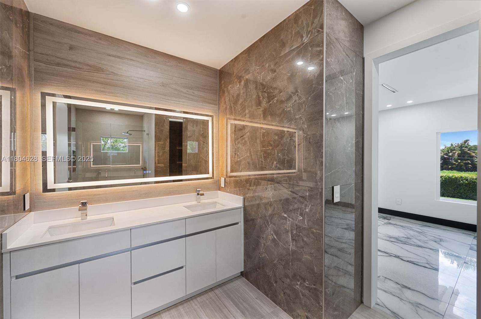 5121 Southwest 210th Terrace Southwest Ranches, FL 33332 - Photo 35 of 70 a bathroom with a sink and a large mirror