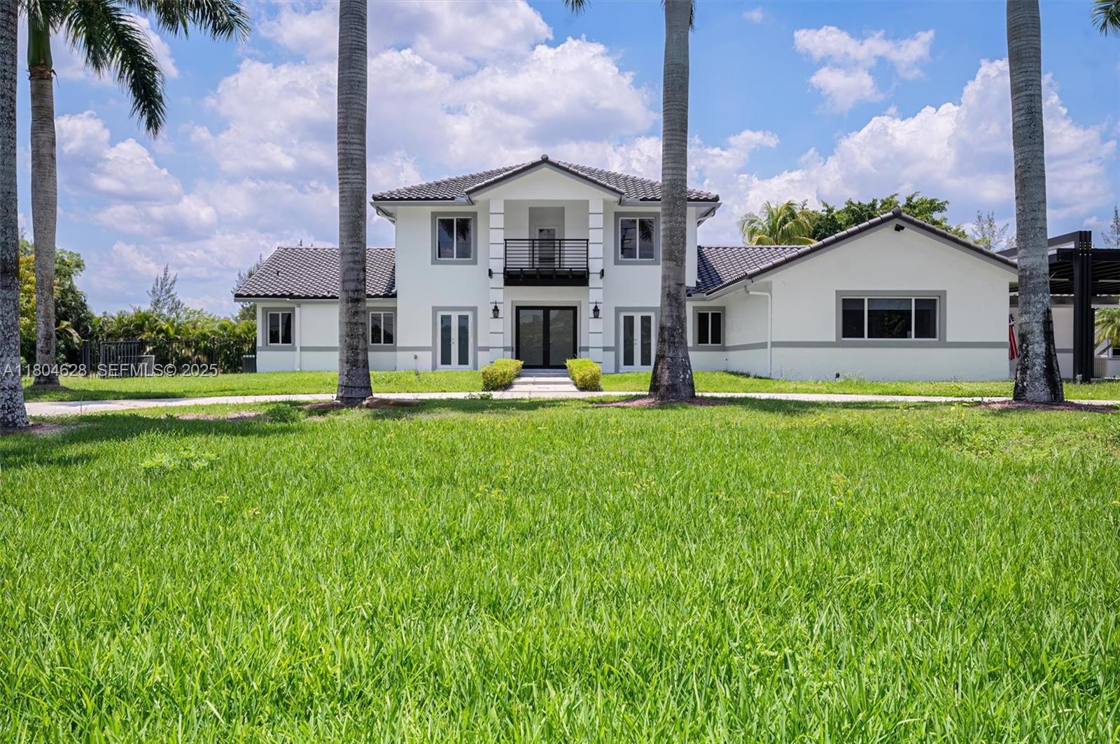 5121 Southwest 210th Terrace Southwest Ranches, FL 33332 - Photo 5 of 70 a front view of house with yard and green space