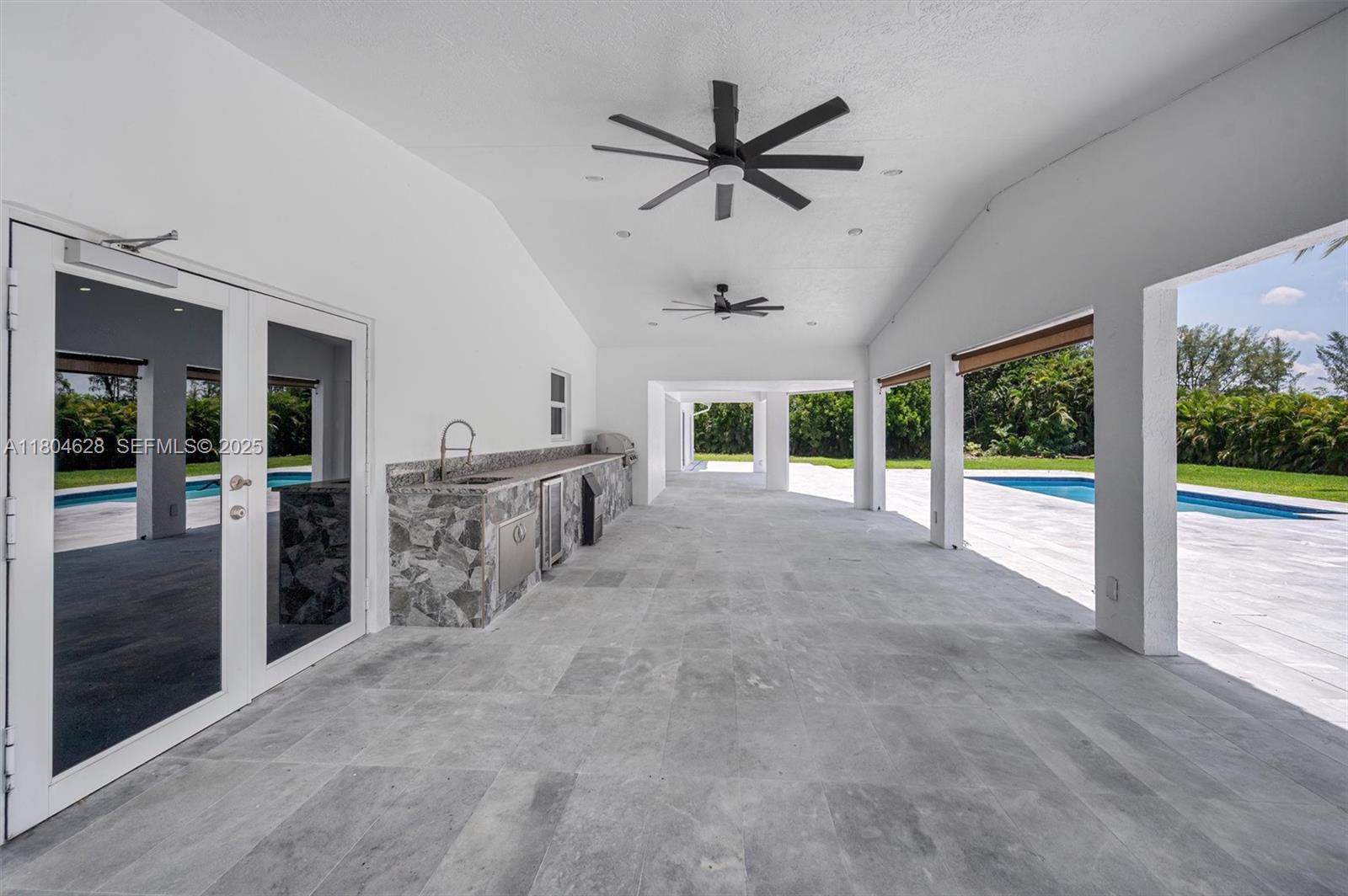 5121 Southwest 210th Terrace Southwest Ranches, FL 33332 - Photo 53 of 70 a view of a livingroom with a ceiling fan and window