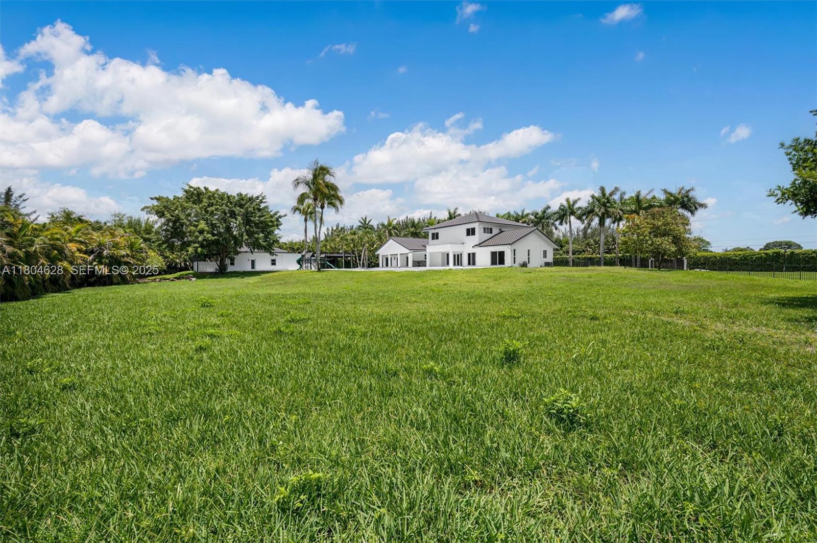5121 Southwest 210th Terrace Southwest Ranches, FL 33332 - Photo 55 of 70 a view of a big yard with potted plants and large tree