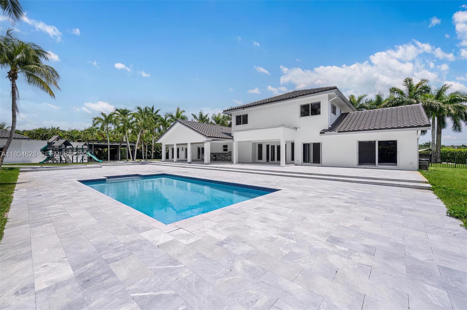 5121 Southwest 210th Terrace Southwest Ranches, FL 33332 - Photo 56 of 70 a swimming pool with outdoor seating