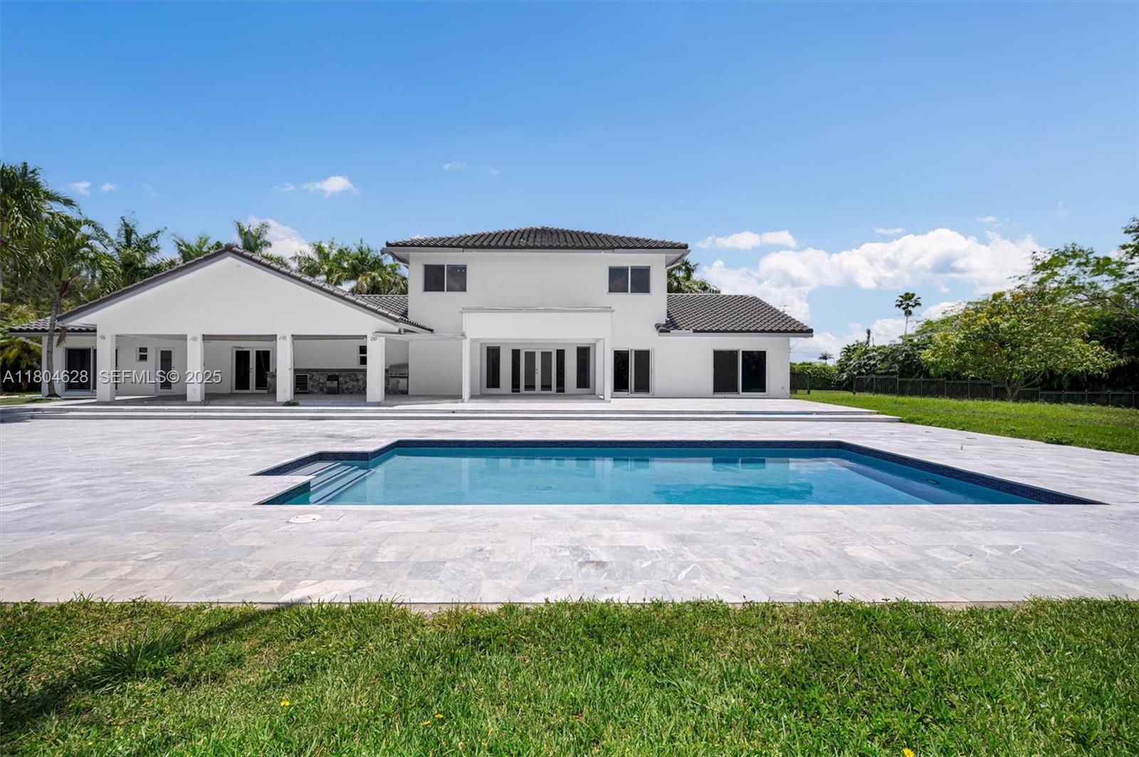 5121 Southwest 210th Terrace Southwest Ranches, FL 33332 - Photo 57 of 70 a front view of a house with a yard