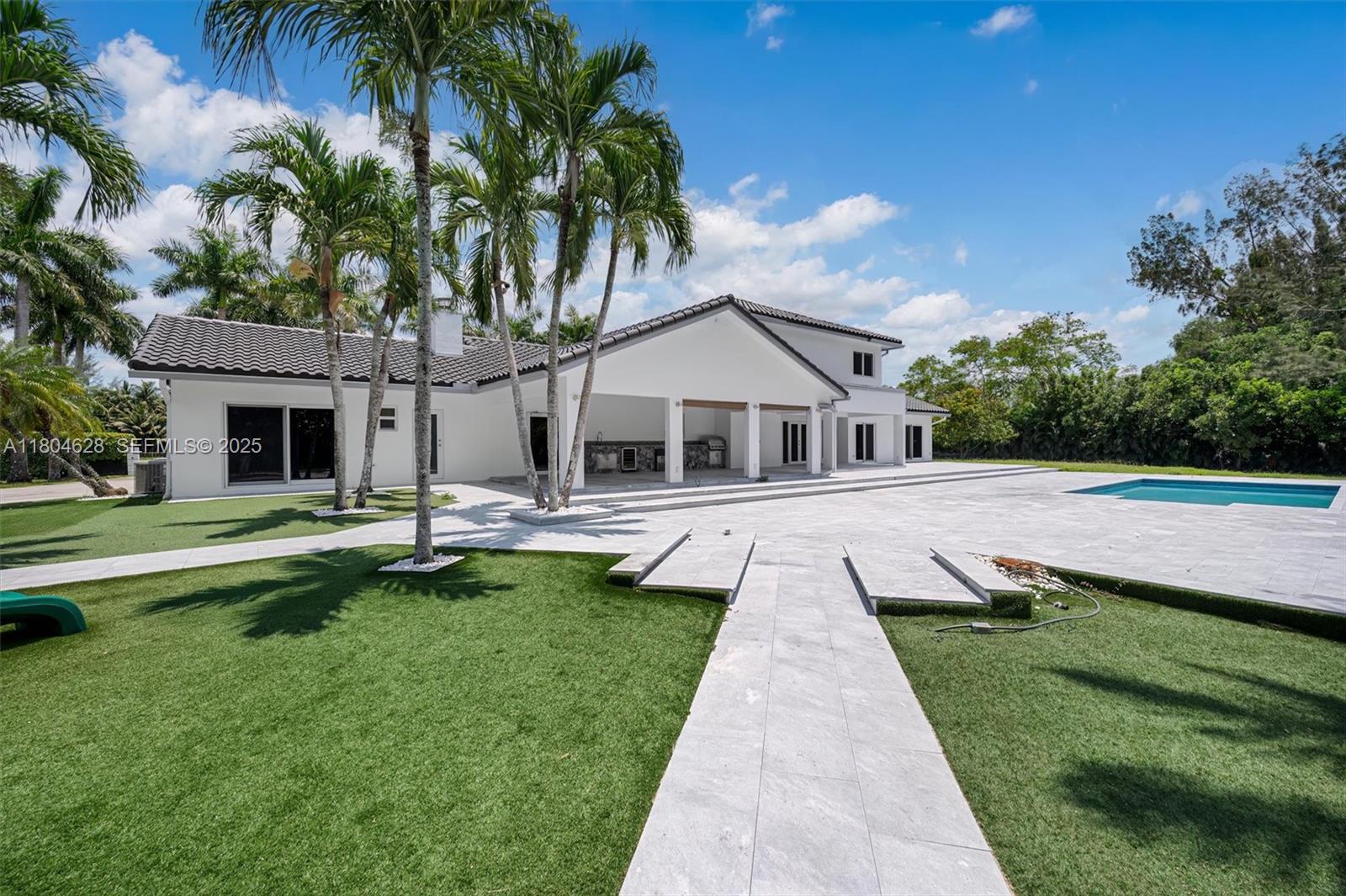 5121 Southwest 210th Terrace Southwest Ranches, FL 33332 - Photo 58 of 70 a front view of a house with a yard