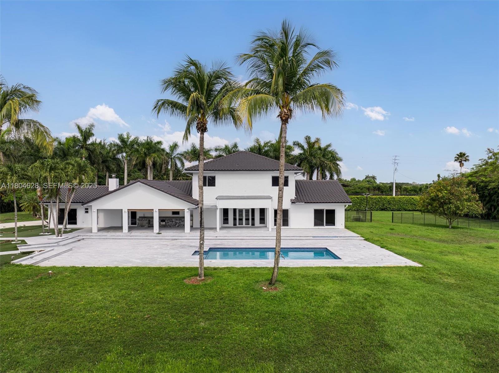 5121 Southwest 210th Terrace Southwest Ranches, FL 33332 - Photo 65 of 70 a view of a house with a backyard