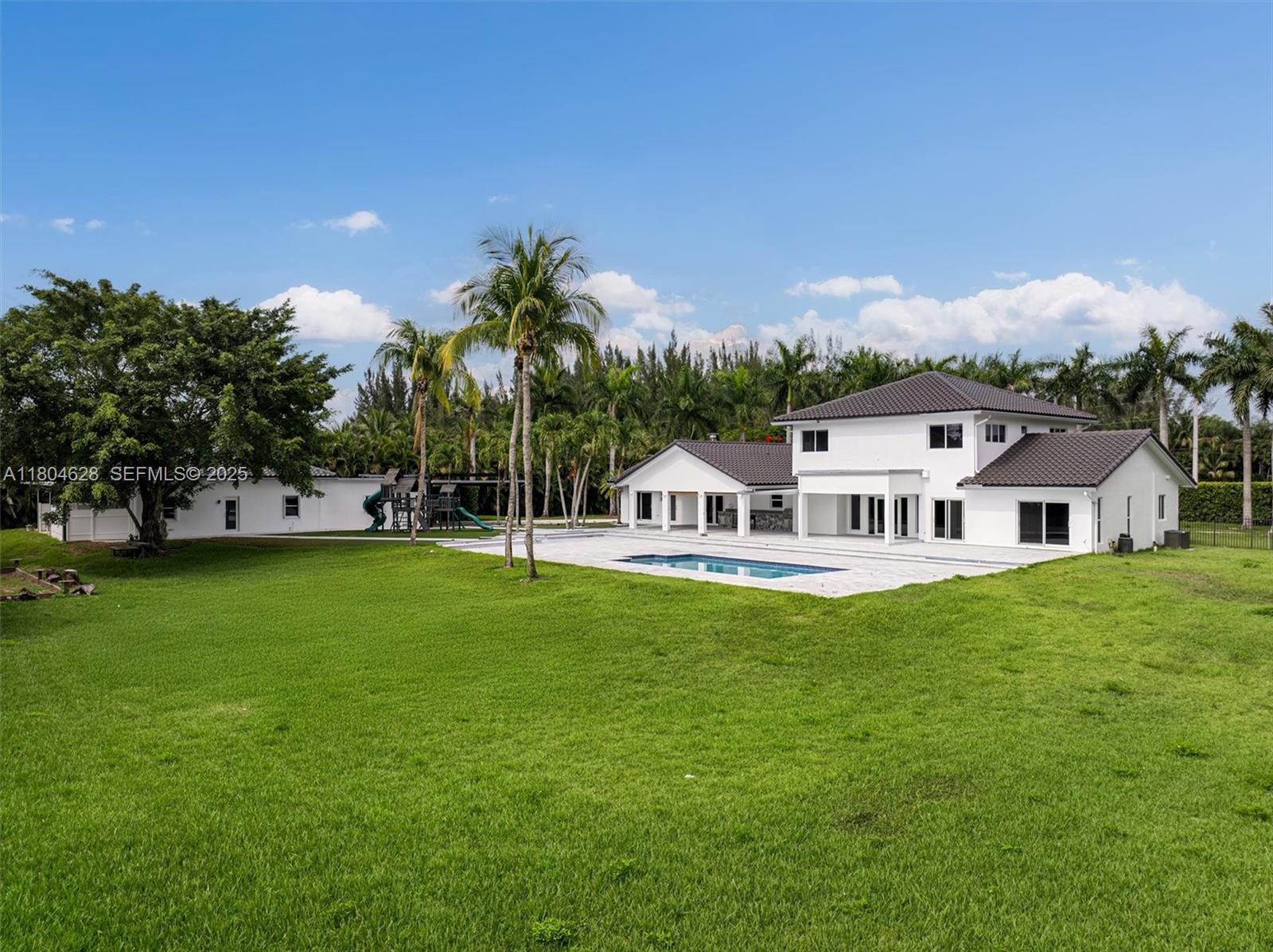 5121 Southwest 210th Terrace Southwest Ranches, FL 33332 - Photo 66 of 70 a view of a house with a big yard