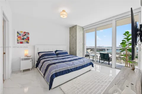 a bedroom with a bed and a fireplace