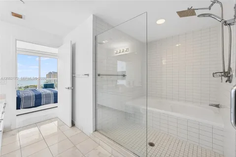 a bathroom with a shower and a sink