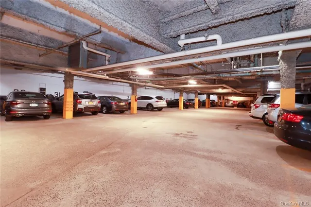 a view of parking garage with cars