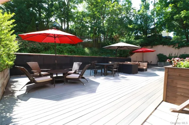 an outdoor space with patio lots of furniture and umbrella