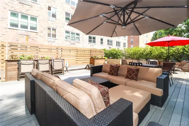 a view of a patio with couches and umbrella