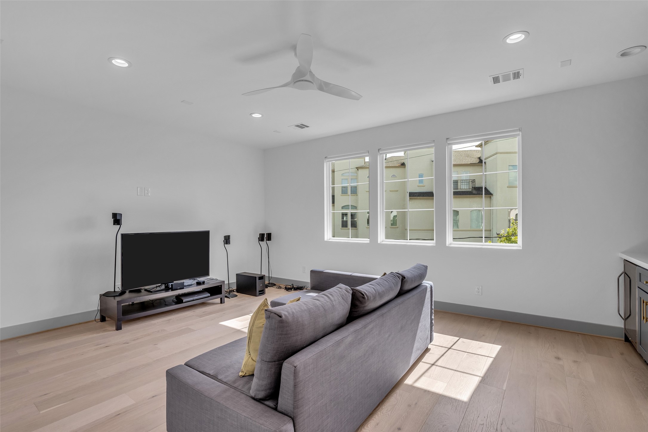 1724 Ridgewood Street Houston, TX 77006 - Photo 30 of 38 An additional view of the game room highlights the spacious living area, with windows that overlook the neighborhood and bring in natural light throughout the space.