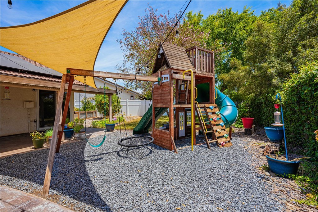 27571 Cabrillo Drive Menifee, CA 92586 - Photo 36 of 56 a view of a chairs and fire pit in backyard of the house