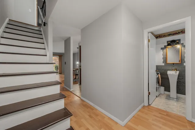 a view of a hallway with closet and stairs