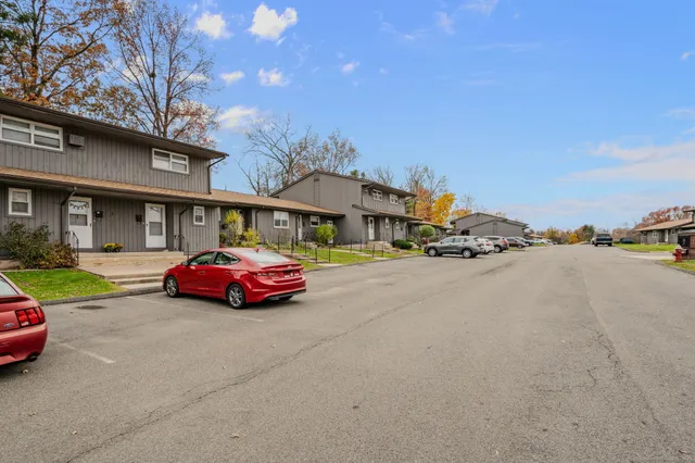 a park view with a table and chairs with wooden fence
