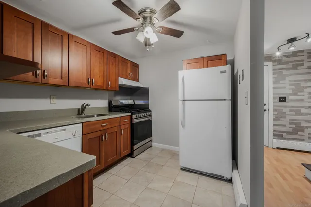 a kitchen with stainless steel appliances granite countertop a refrigerator sink and cabinets