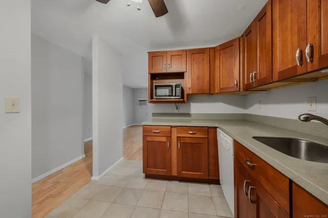 a kitchen with stainless steel appliances granite countertop a sink and cabinets
