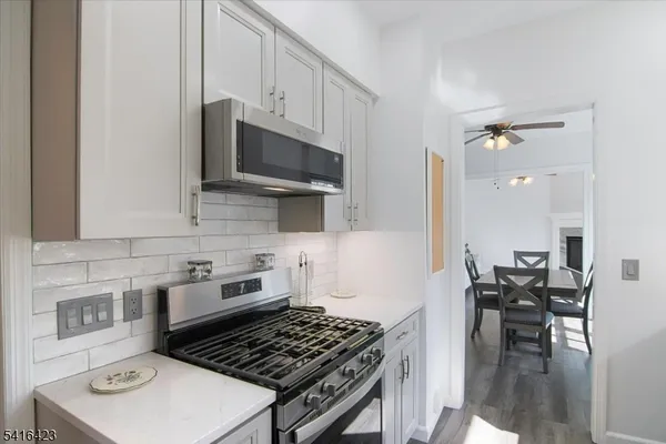 a kitchen with a stove a sink and a microwave