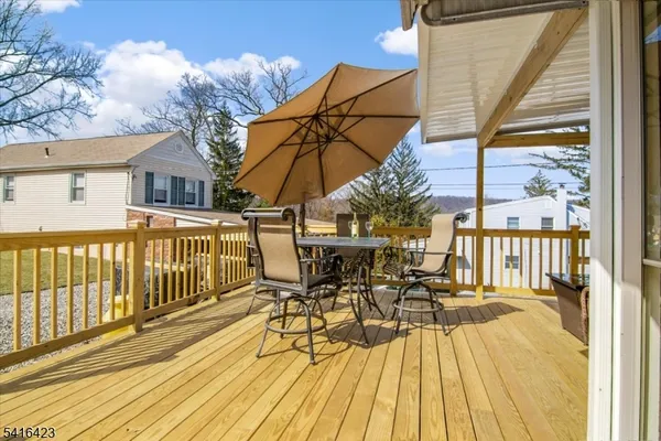a view of a patio with a table and chairs