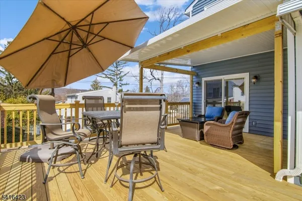 a patio with glass top table and chairs