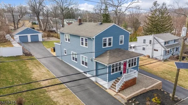 a aerial view of a house with swimming pool in front of it