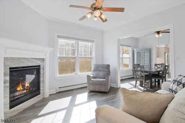 a living room with furniture a fireplace and a large window