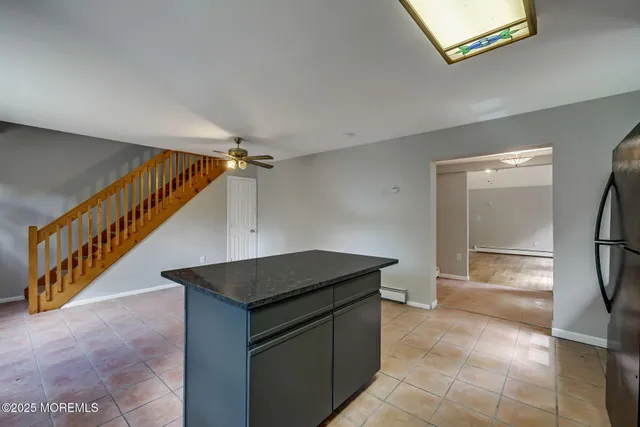 a kitchen with stainless steel appliances granite countertop a sink and a stove