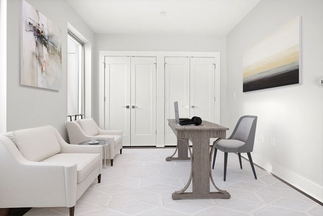 a work room with furniture and flat screen tv