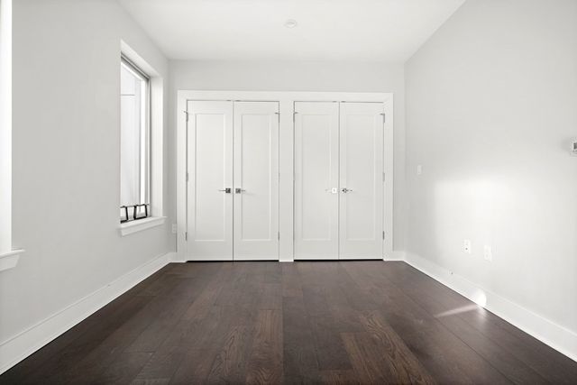 an empty room with wooden floor