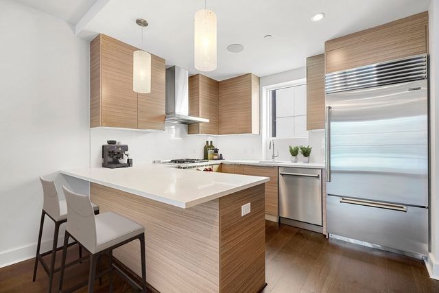 a kitchen with a sink stove and refrigerator