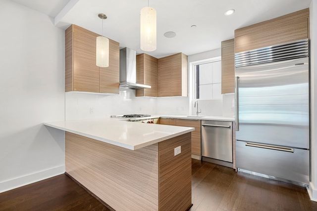 a kitchen with a sink stove and refrigerator