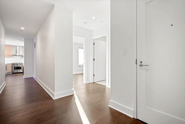 a view of a hallway with wooden floor