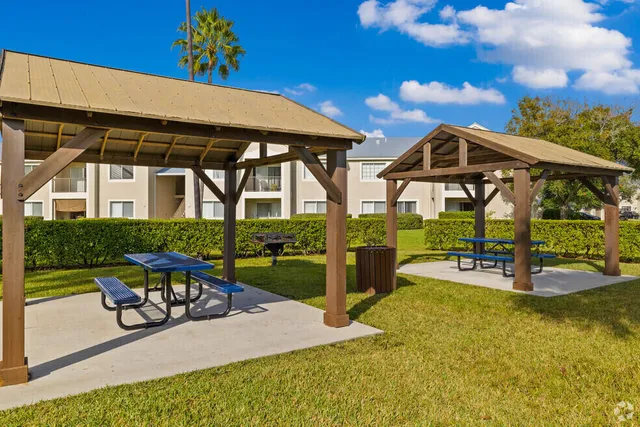 a view of a house with a yard and potted plants