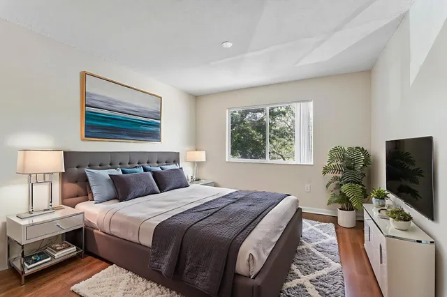 a bedroom with a bed and a flat screen tv