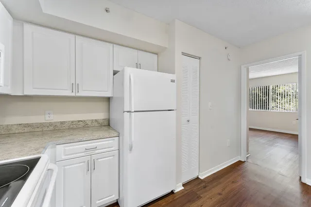 a white refrigerator freezer sitting inside of a kitchen