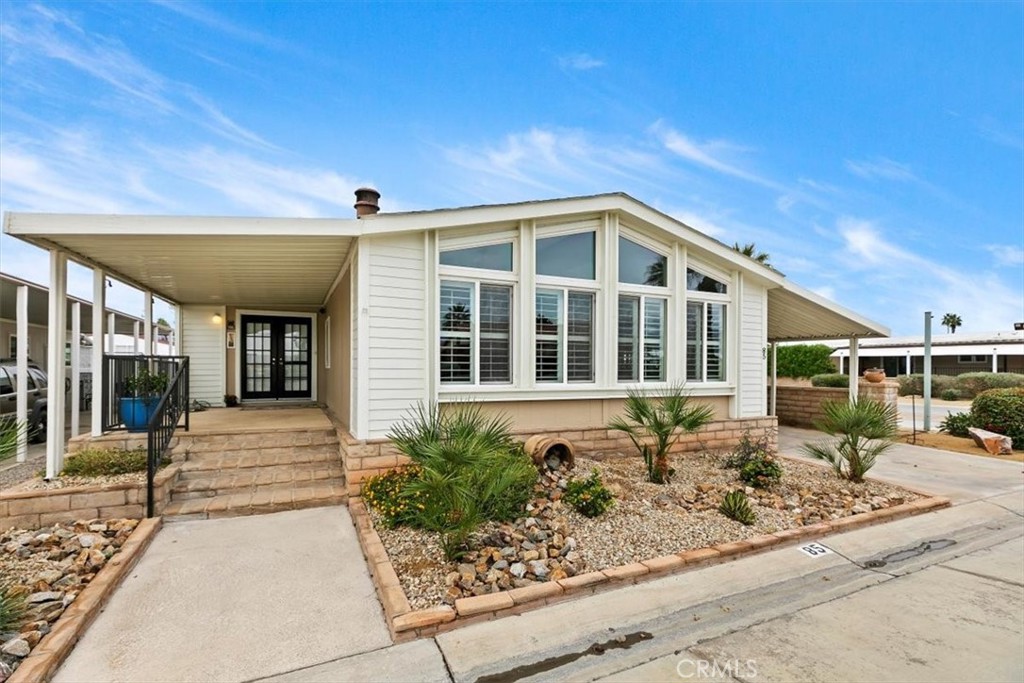 46618 Madison Street, Unit 85 Indio, CA 92201 - Photo 14 of 50 a front view of a house with garden