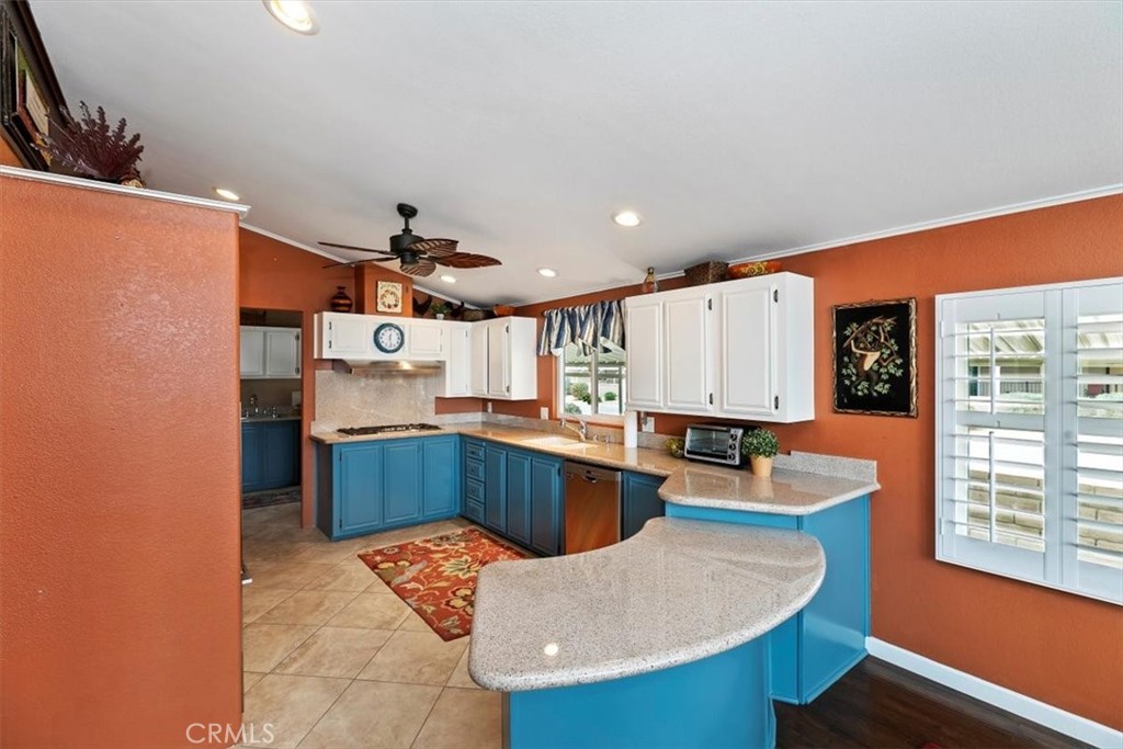 46618 Madison Street, Unit 85 Indio, CA 92201 - Photo 31 of 50 a kitchen with stainless steel appliances kitchen island granite countertop a sink and cabinets