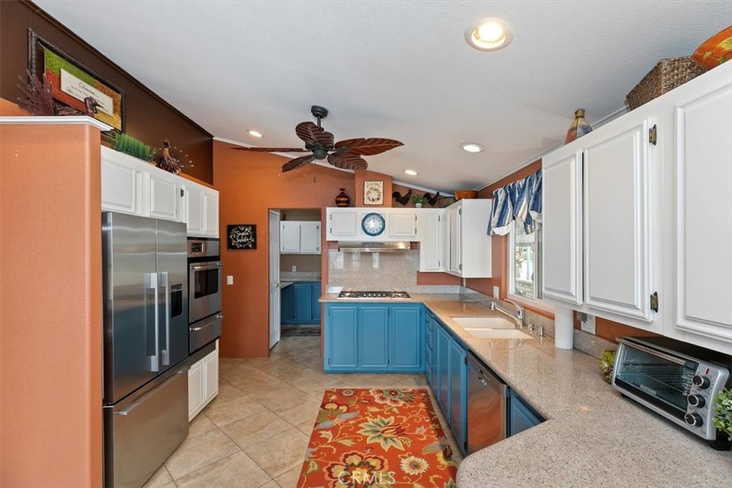46618 Madison Street, Unit 85 Indio, CA 92201 - Photo 32 of 50 a kitchen with stainless steel appliances granite countertop a refrigerator and stove