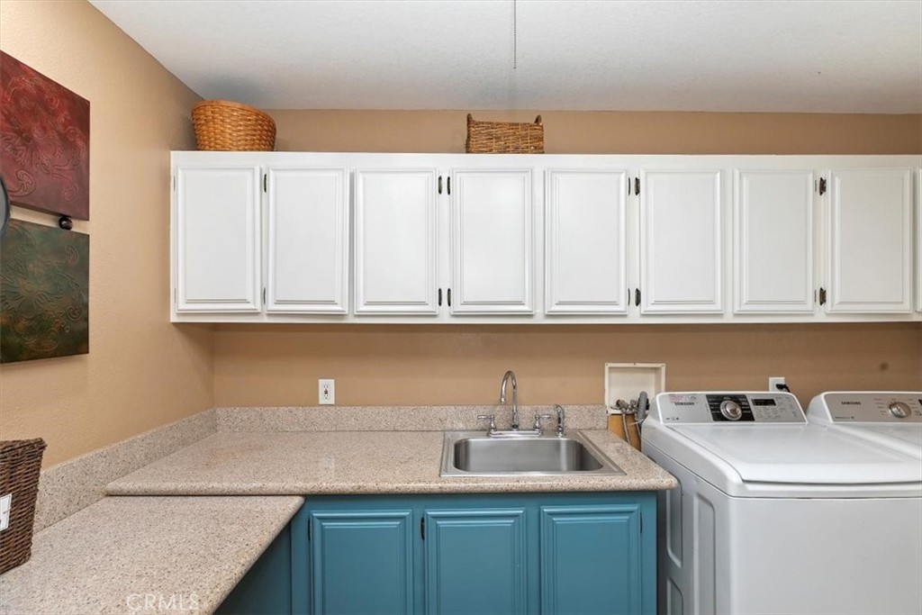 46618 Madison Street, Unit 85 Indio, CA 92201 - Photo 35 of 50 a kitchen with granite countertop a sink a stove and cabinets