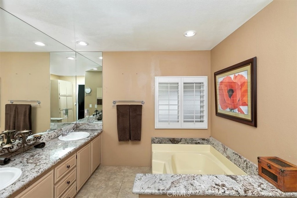 46618 Madison Street, Unit 85 Indio, CA 92201 - Photo 46 of 50 a spacious bathroom with a granite countertop tub sink and mirror
