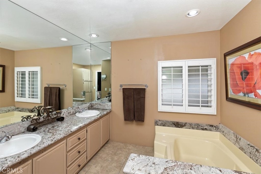 46618 Madison Street, Unit 85 Indio, CA 92201 - Photo 47 of 50 a bathroom with a tub sink and mirror