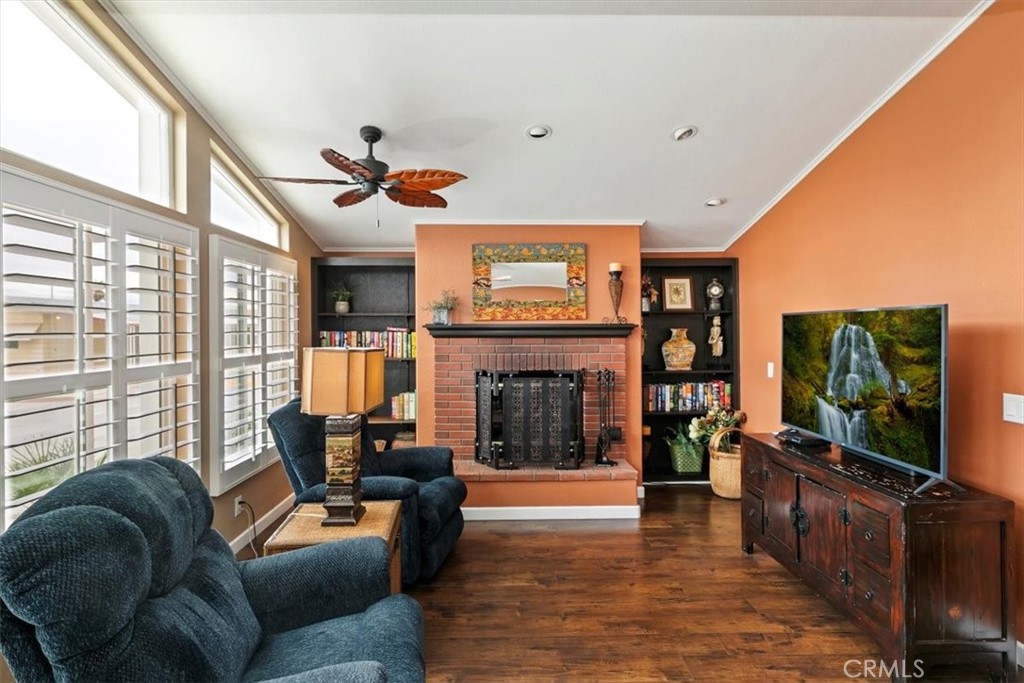 46618 Madison Street, Unit 85 Indio, CA 92201 - Photo 6 of 50 a living room with furniture a fireplace and a flat screen tv