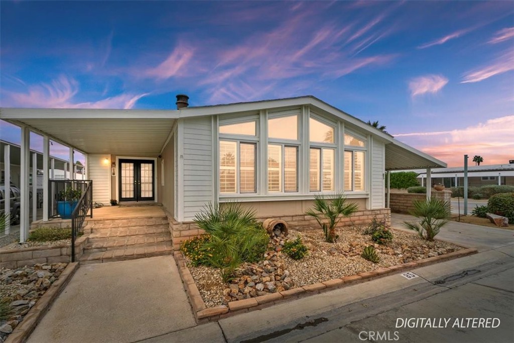 46618 Madison Street, Unit 85 Indio, CA 92201 - Photo 8 of 50 a front view of a house with garden
