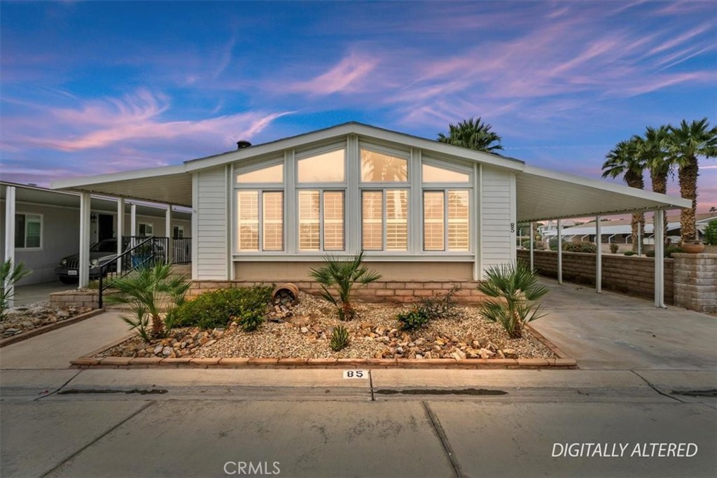 46618 Madison Street, Unit 85 Indio, CA 92201 - Photo 9 of 50 a front view of a house with a yard