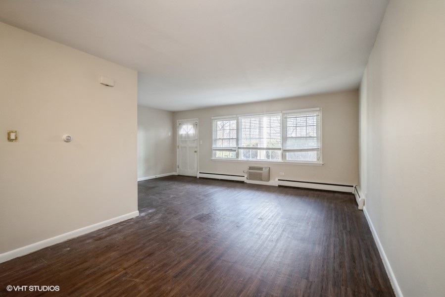340 Waukegan Road, Unit 3 Glenview, IL 60025 - Photo 2 of 6 an empty room with wooden floor and windows