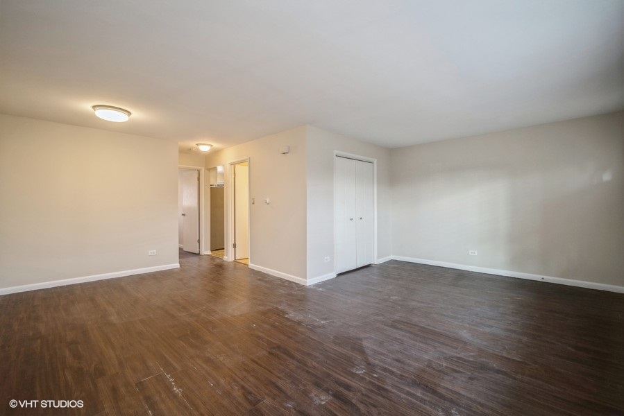 340 Waukegan Road, Unit 3 Glenview, IL 60025 - Photo 3 of 6 a view of an empty room with wooden floor