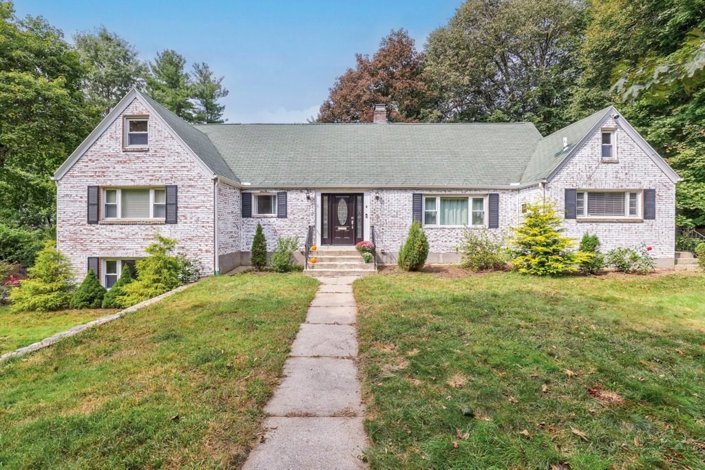 a front view of house with yard and green space