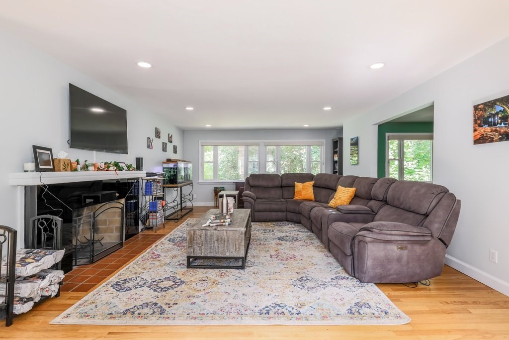 4 Ellis Drive Worcester, MA 01609 - Photo 16 of 32 a living room with furniture a flat screen tv and a fireplace