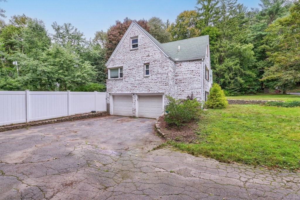 4 Ellis Drive Worcester, MA 01609 - Photo 3 of 32 a front view of a house with a yard and garage